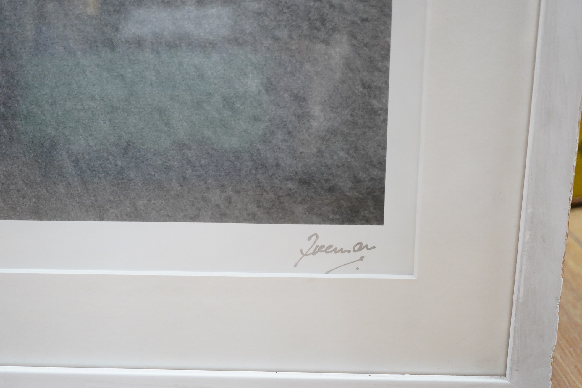 A framed and mounted black and white photograph of The Beatles by Robert Freeman, of a still from the film A Hard Days Night, signed in the margin at the bottom right, 42.5 x 58.5cm
